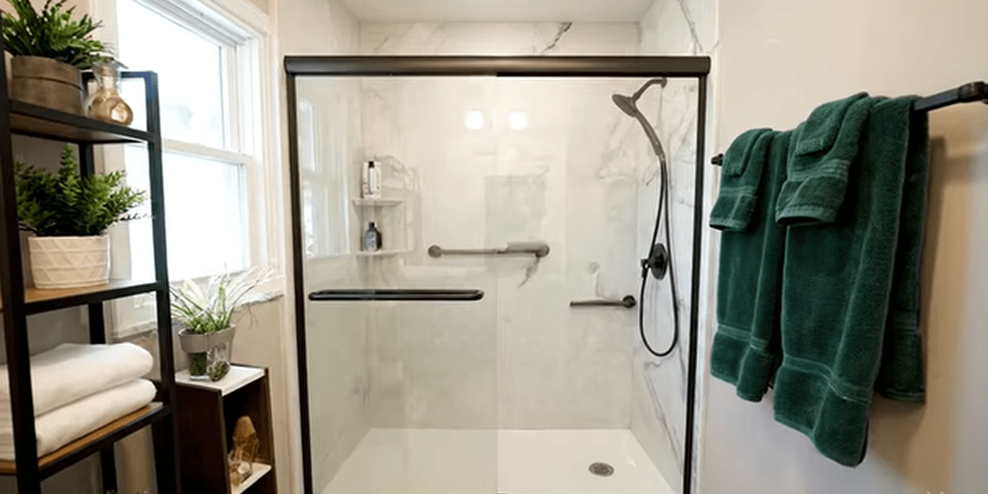 Modern walk-in shower with marble walls and glass door