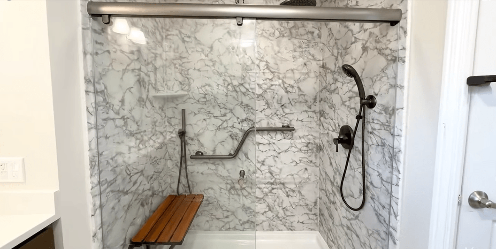 Accessible shower with teak bench and grab bars