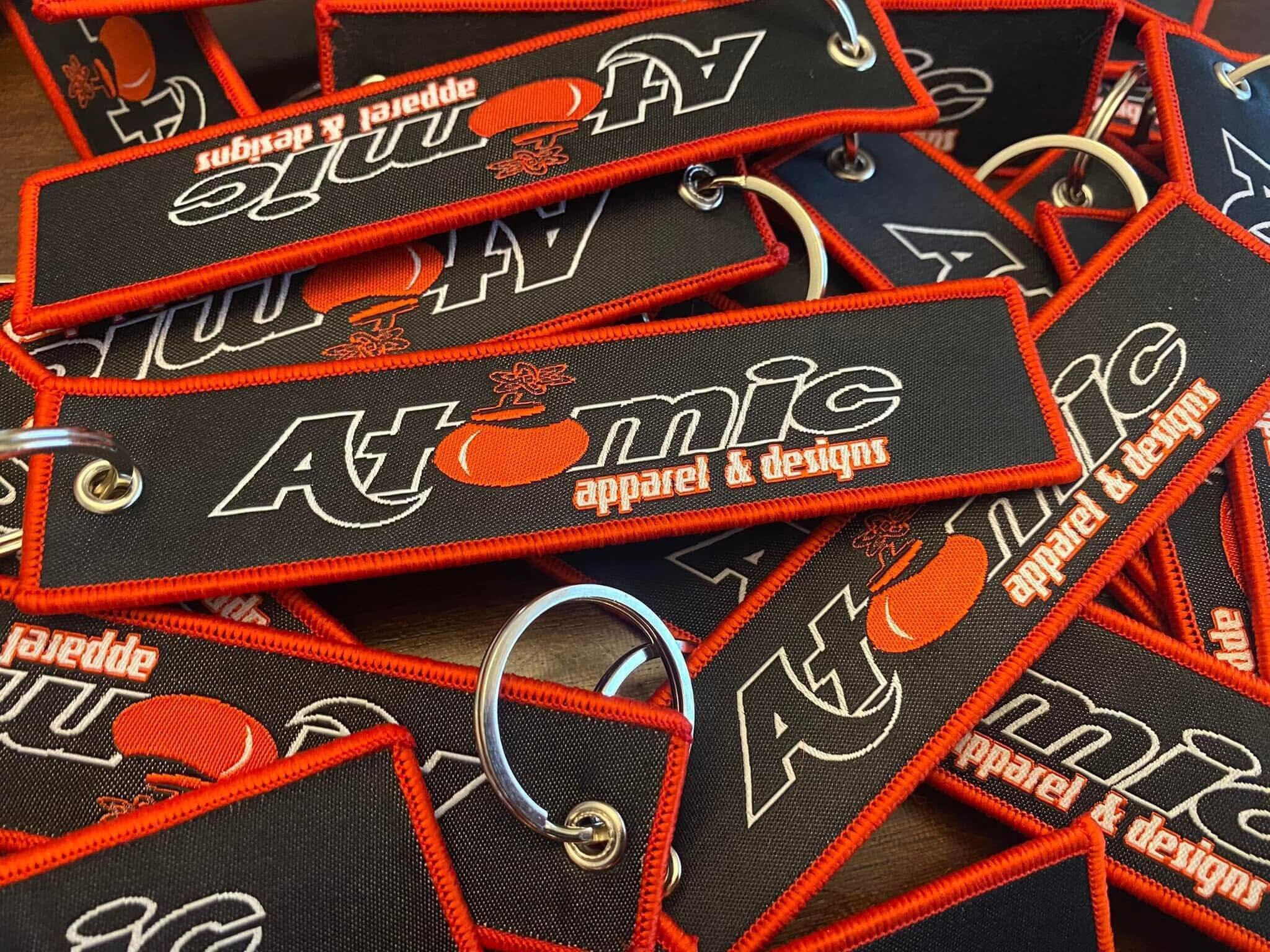 Atomic Apparel & Designs custom key tags with red border stitching