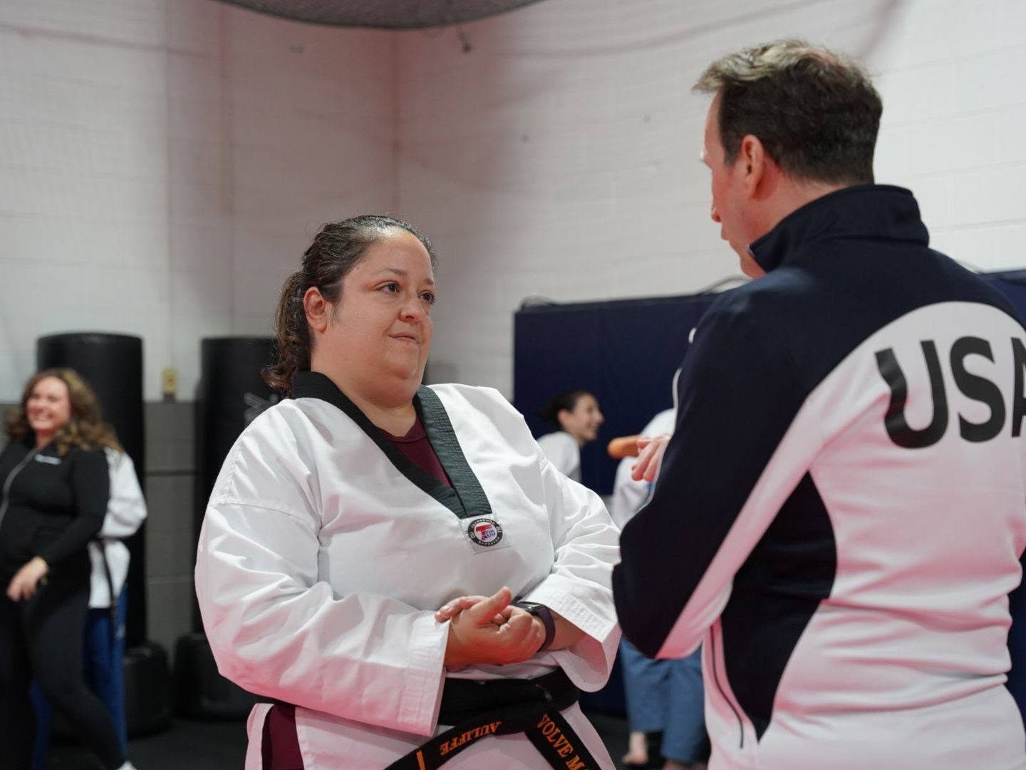 An adult Storm student listening to individual feedback from an instructor