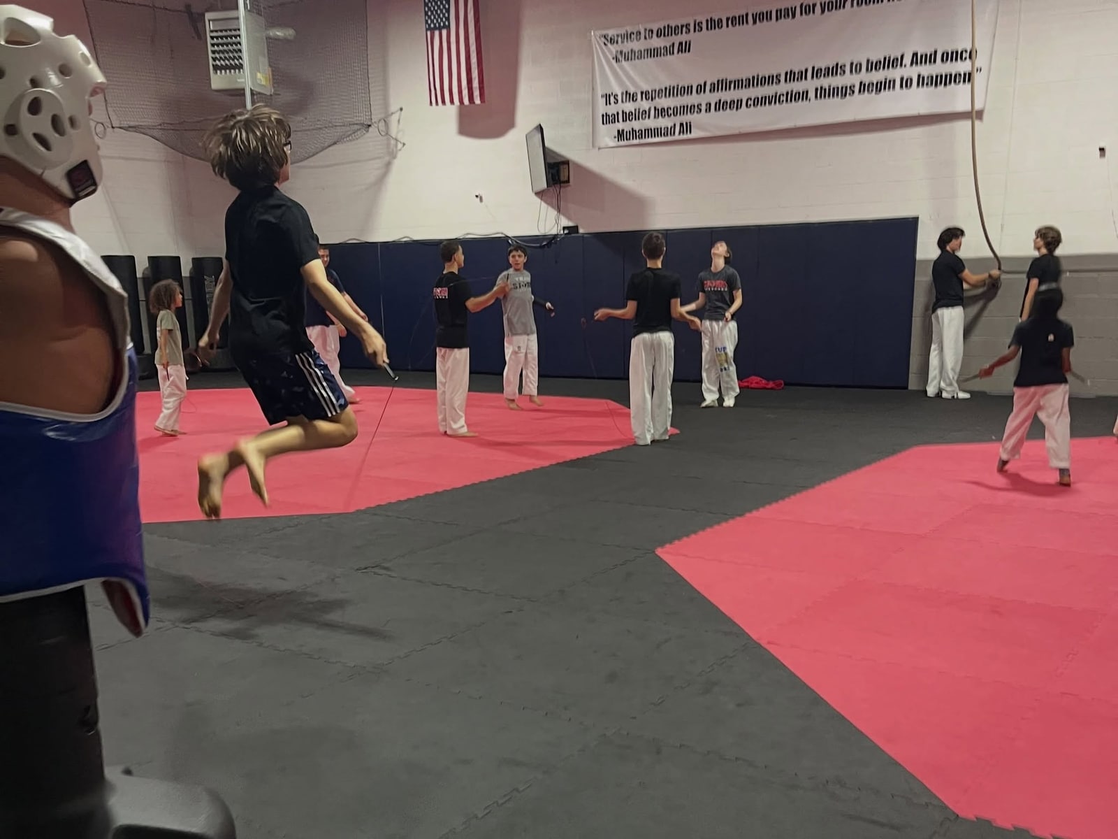 Teen and adult Storm students warming up with jump ropes