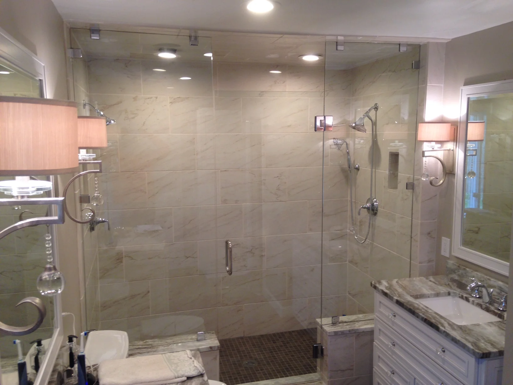 Custom glass shower enclosure in a tiled bathroom