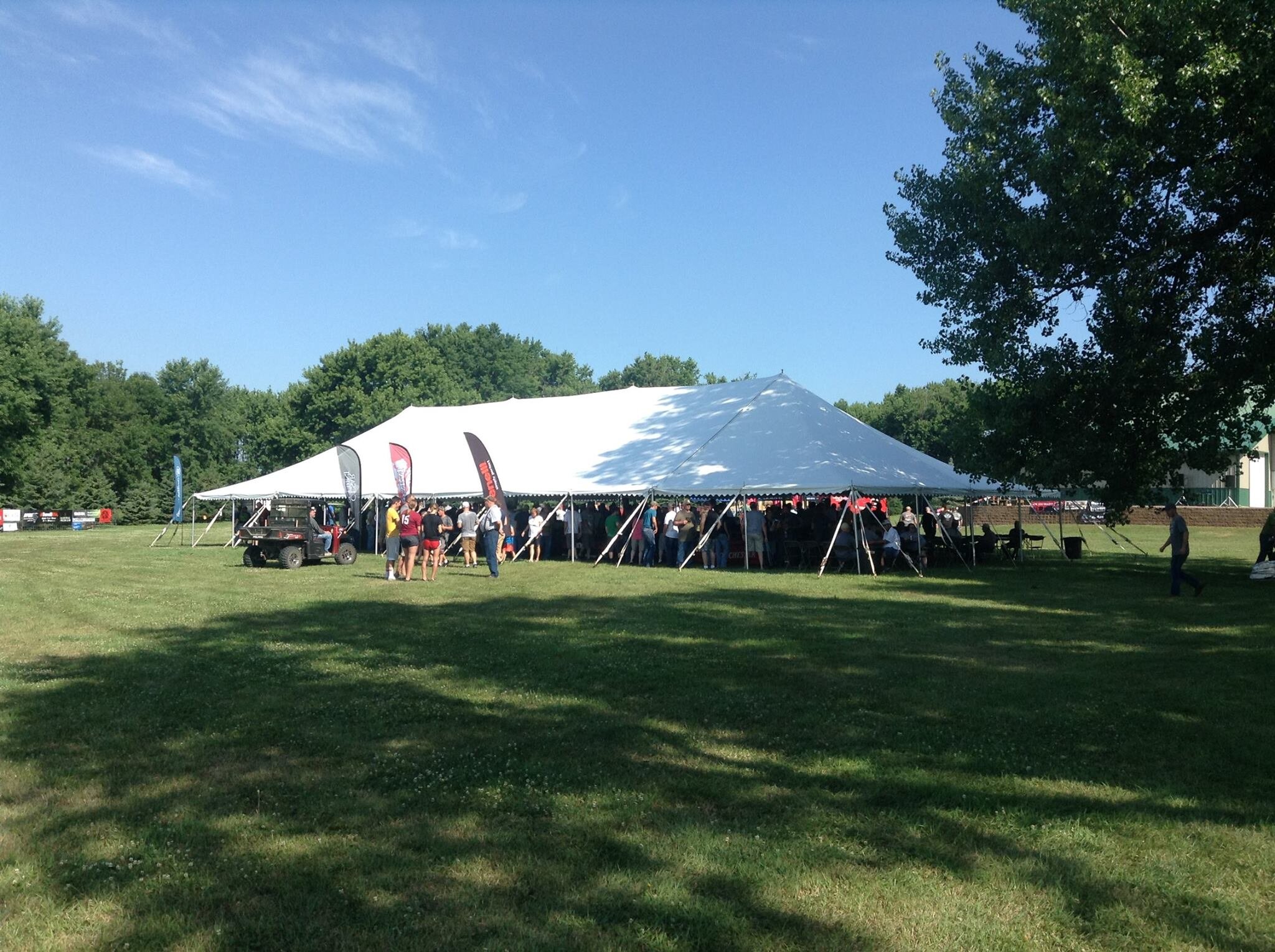 Shotgun Demo Day and store event display at Kjergaard Sports — Benelli, Browning, and Winchester tents with firearms on tables