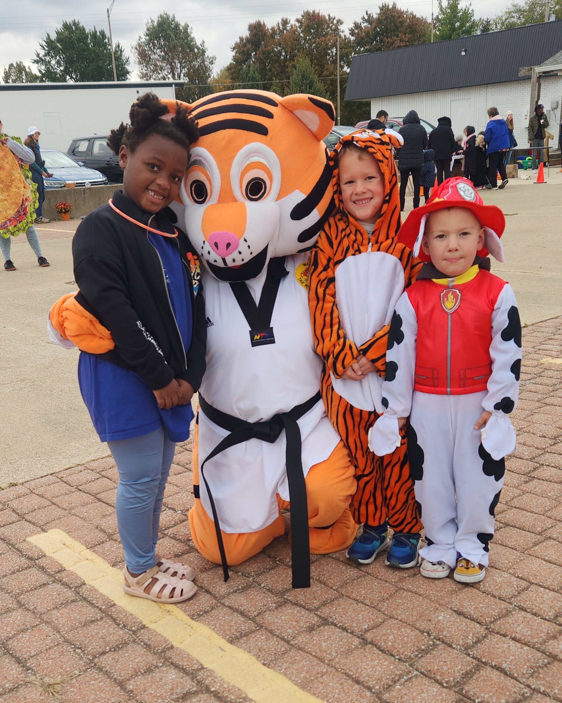 Walker's Martial Arts community event with students and mascot